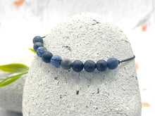 Load image into Gallery viewer, Close-up of dumortierite healing crystal beads showing natural blue stone texture