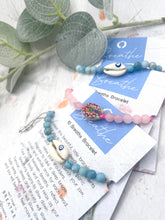 Load image into Gallery viewer, Larimar and Rose Quartz bracelets on their jewellery cards