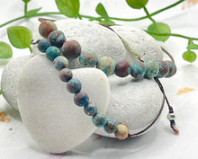 Load image into Gallery viewer, Blie Green Calsilica Anxiety Calming Bracelets. 6mm and 8mm stones on a cotton cord the help alleviate anxiety and stress
