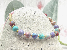 Load image into Gallery viewer, lilac and blue sea sediment stones on a pink cord with tiny gold coloured glass beads to finish it off
